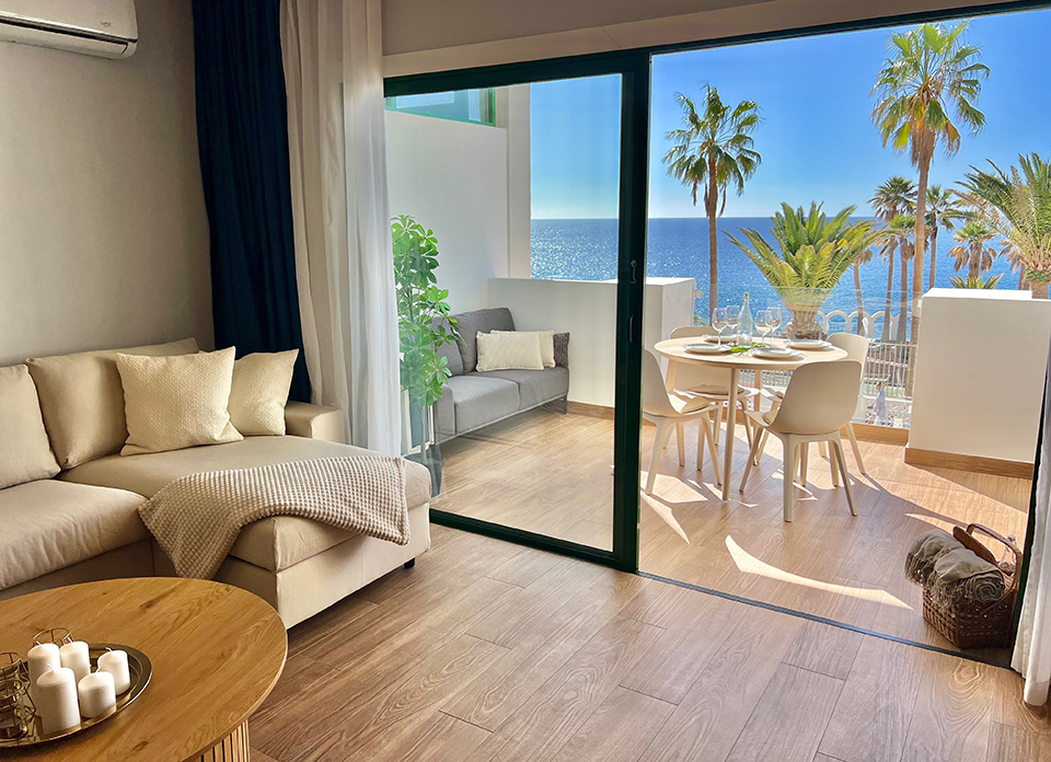 Living room in Callao Ocean View Luxury Apartment with bright interior and exit to terrace overlooking the ocean.