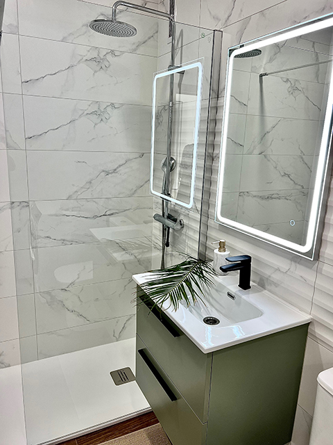 Sink and mirror in the apartment bathroom, a bright and orderly daily care zone.