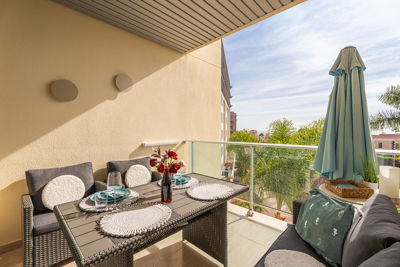 Amplia terraza del apartamento en Islas Canarias, decorada con mesa y platos de comida, ideal para disfrutar al aire libre.